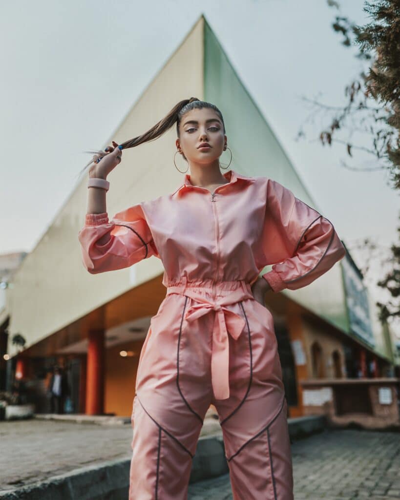 woman wearing pink jumpsuit with black details